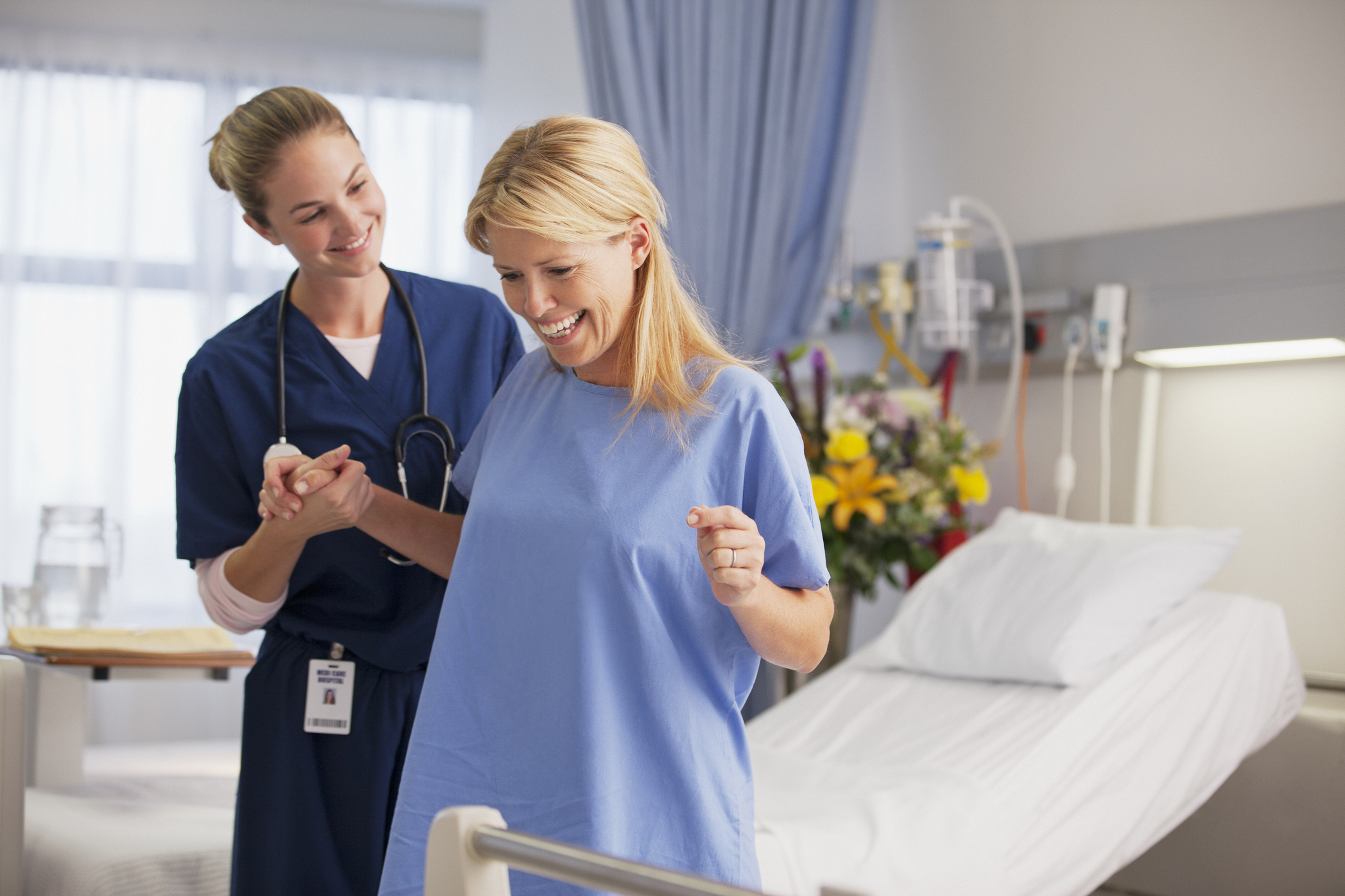 nurse helping patient stand up