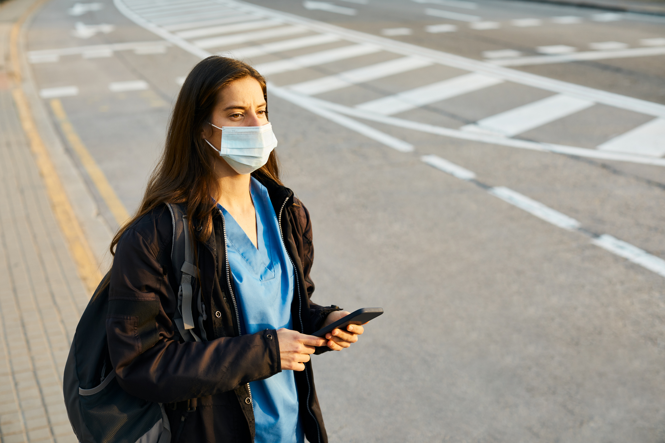 travel nurse standing on side of road