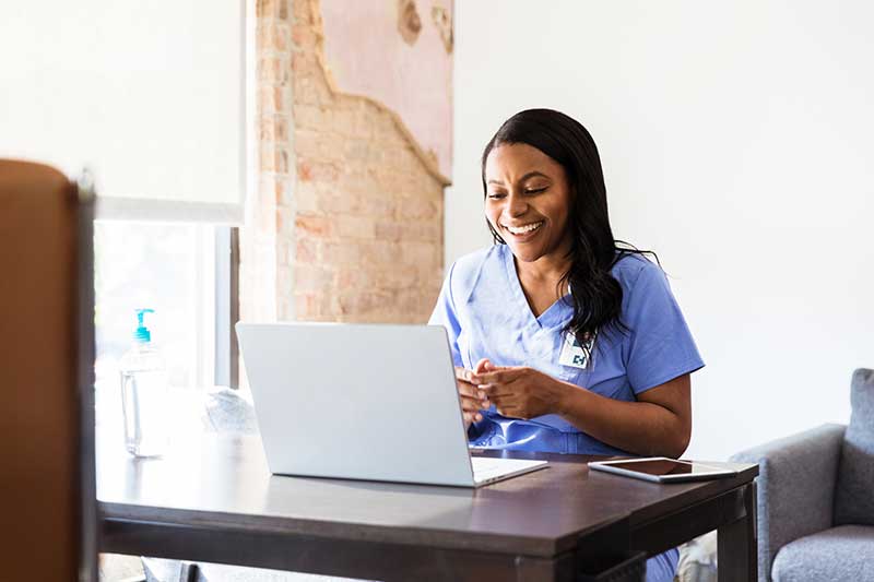 nurse using laptop at desk
