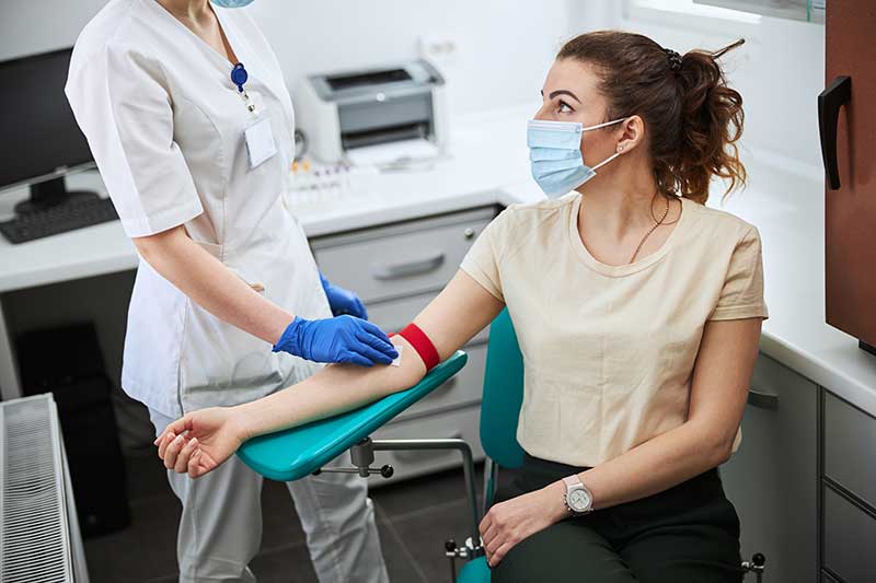 Nurse swabbing a patient's arm