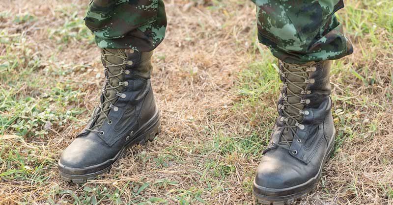 Close up of military boots on grass
