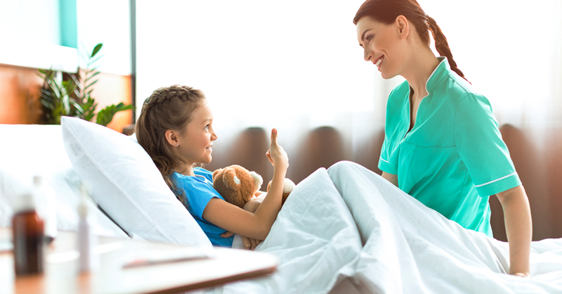 Nurse at child patient's bedside